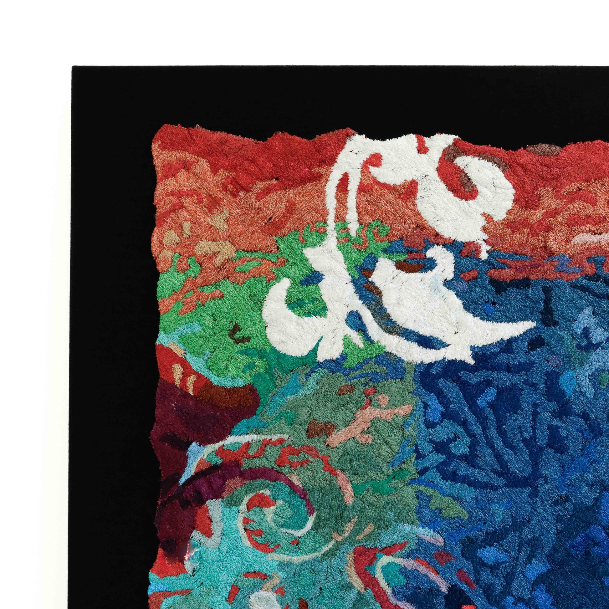 A close-up of a thread tapestry with a mix of patterns, showcasing intricate stitching and colorful thread.