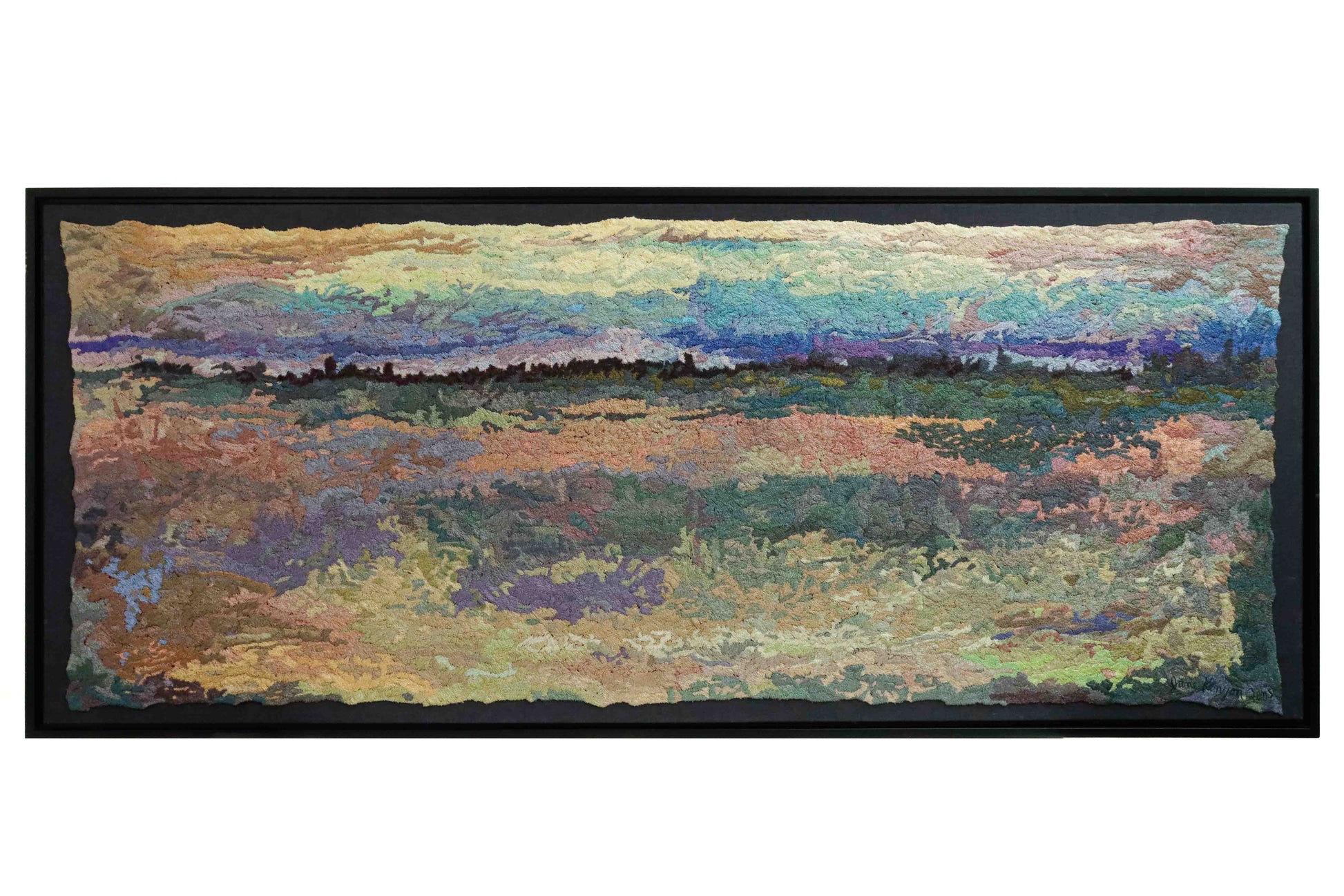 A wide, rectangular thread tapestry with a landscape design, showcasing intricate stitching and colorful thread.