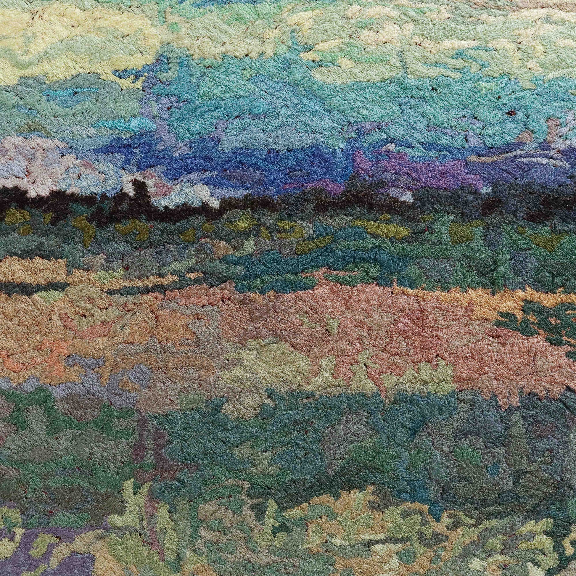 A close-up of a thread tapestry with a landscape design, showcasing intricate stitching and colorful thread.