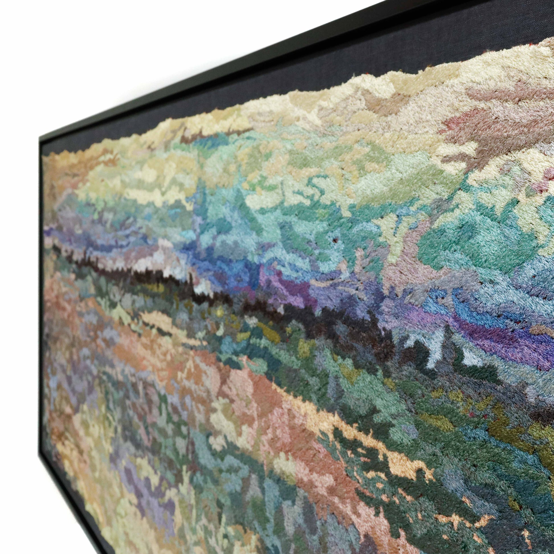 A framed thread tapestry, angled view, showcasing intricate stitching and colorful thread in a landscape thread painting.