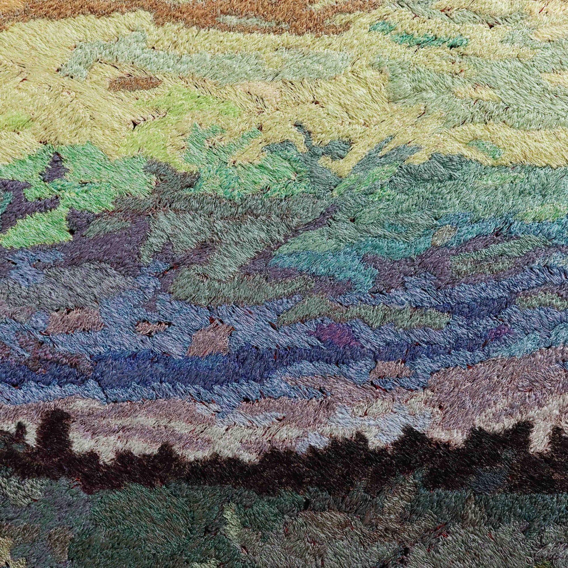 A close-up of a thread tapestry with a landscape design, showcasing intricate stitching and colorful thread.