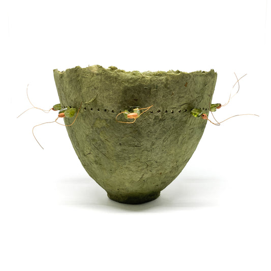 Handmade green plant fiber bowl with a decorative copper wire and bead detail around the rim.