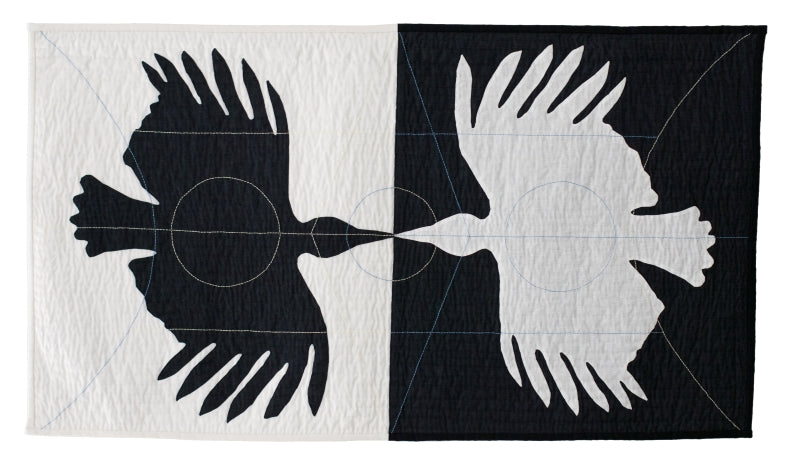 Textile art: mirrored bird silhouettes in contrasting panels, connected by circular and linear stitching details.