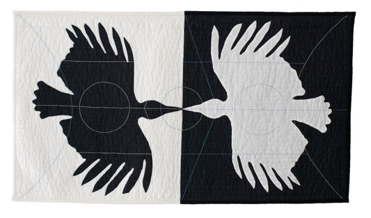 Textile art: mirrored bird silhouettes in contrasting panels, connected by circular and linear stitching details.
