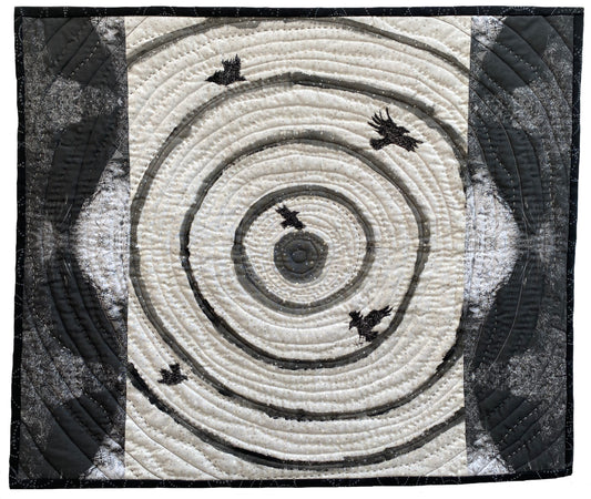 Textile art: concentric swirling lines with five dark birds scattered across the design.