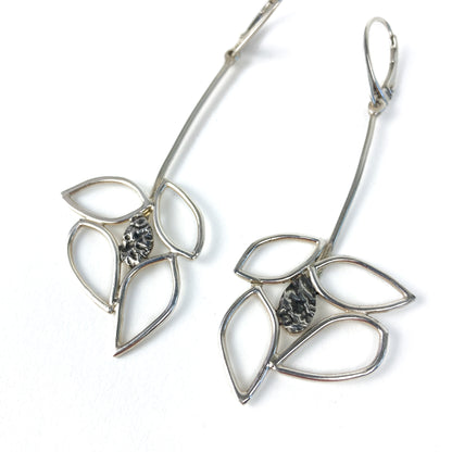 Angled view of two silver Dogwood Drops earrings showing the leaf outlines and textured centers.