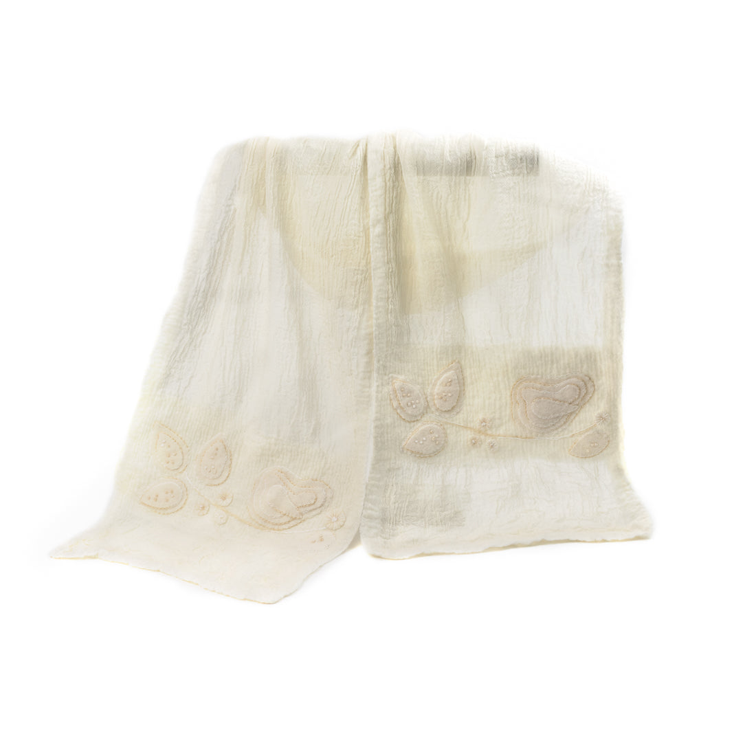 A soft, textured Merino wool shawl with delicate floral embroidery on a plain background.