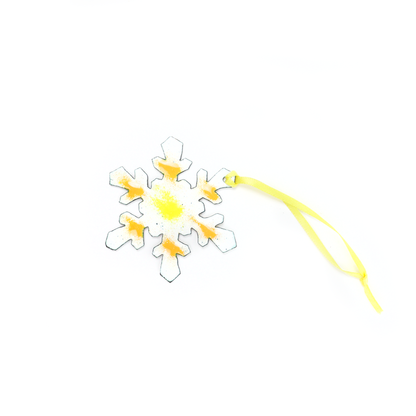 Handmade Snowflake Ornament featuring yellow and orange details with attached hanging ribbon.