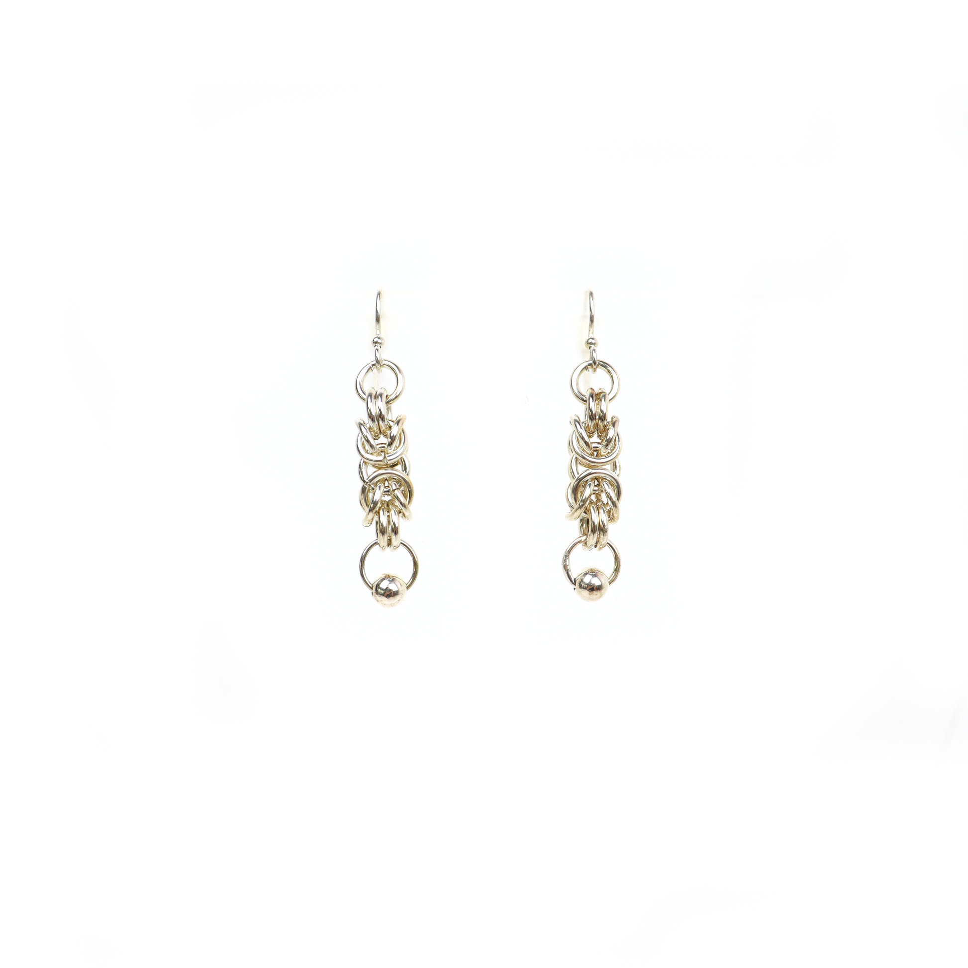 Front view of King Chain Dangle Earrings with detailed silver rings and a small silver ball at the bottom.
