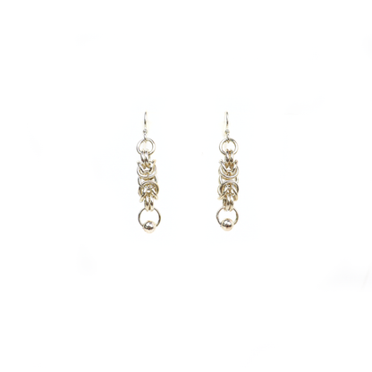 Front view of King Chain Dangle Earrings with detailed silver rings and a small silver ball at the bottom.