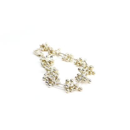 Spaced Barbell Bracelet featuring clusters of silver balls connected by rectangular bar links.