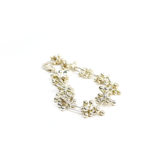 Spaced Barbell Bracelet featuring clusters of silver balls connected by rectangular bar links.