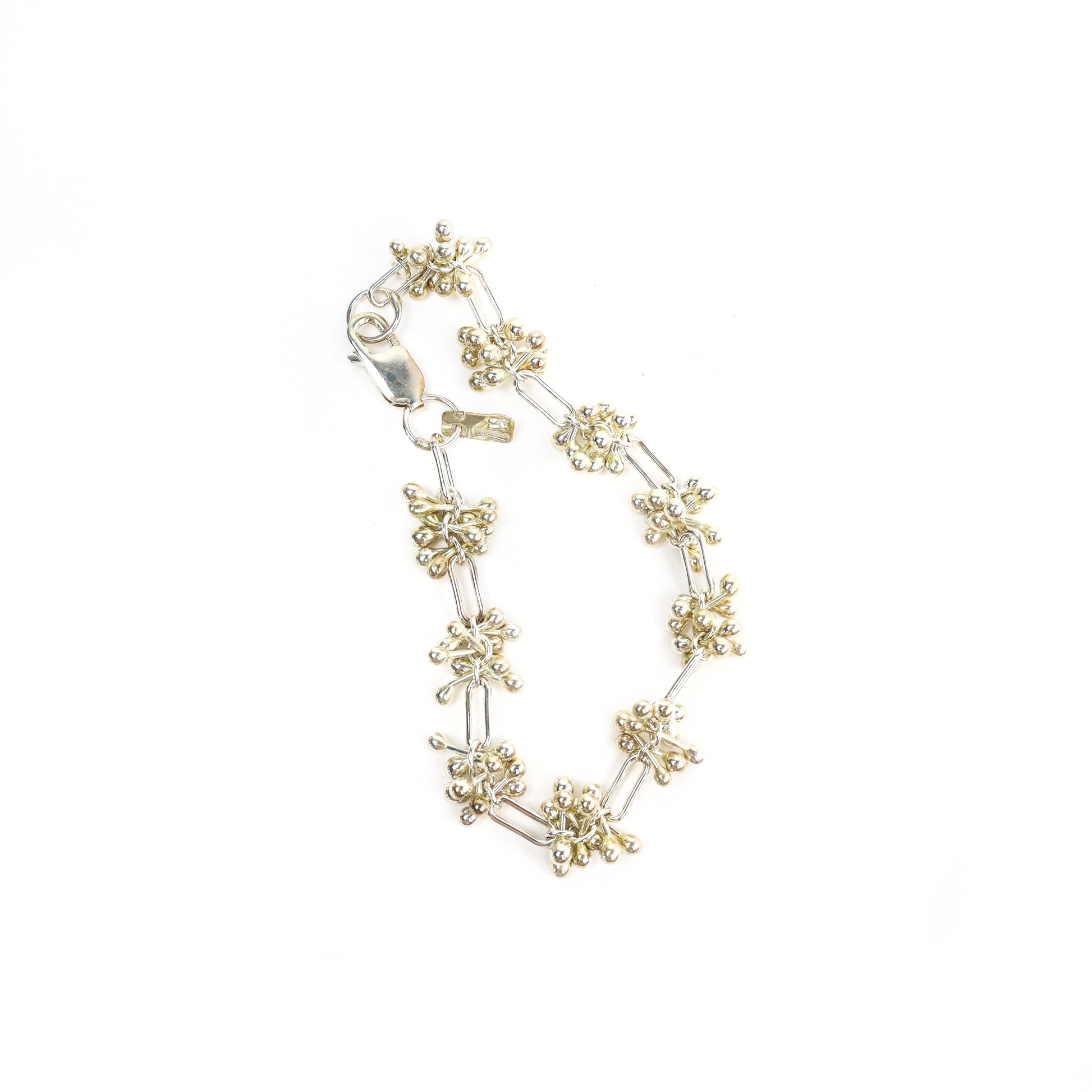 Top view of Spaced Barbell Bracelet with alternating silver ball clusters and rectangular links.