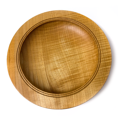 A light brown wooden bowl with a flat rim, top-down view.
