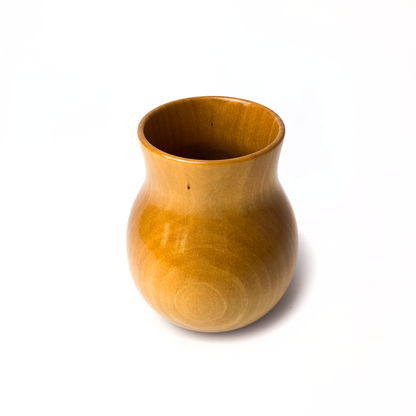 A small, light brown wooden vase.