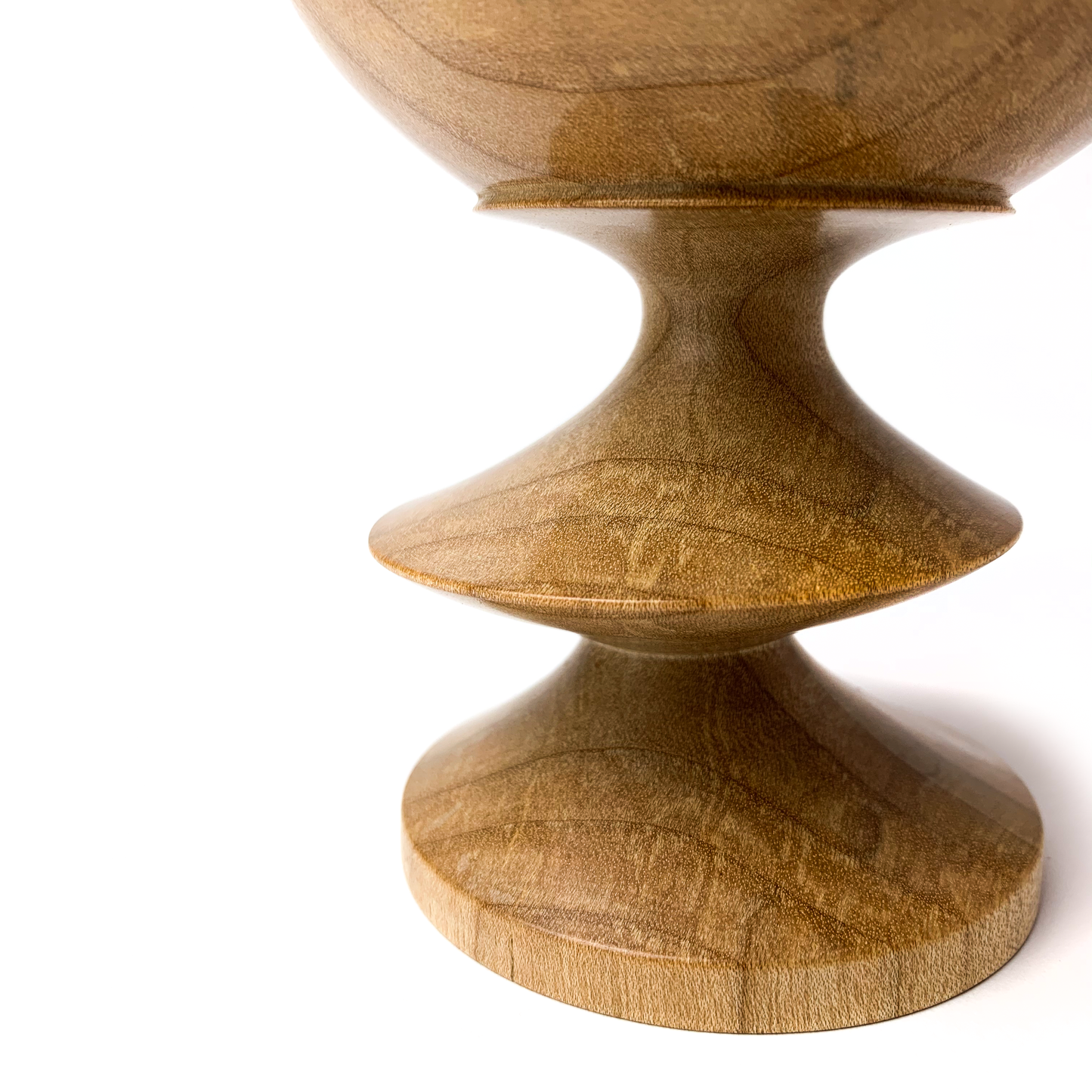 A light brown maple goblet with a twisted stem, close-up angled view.