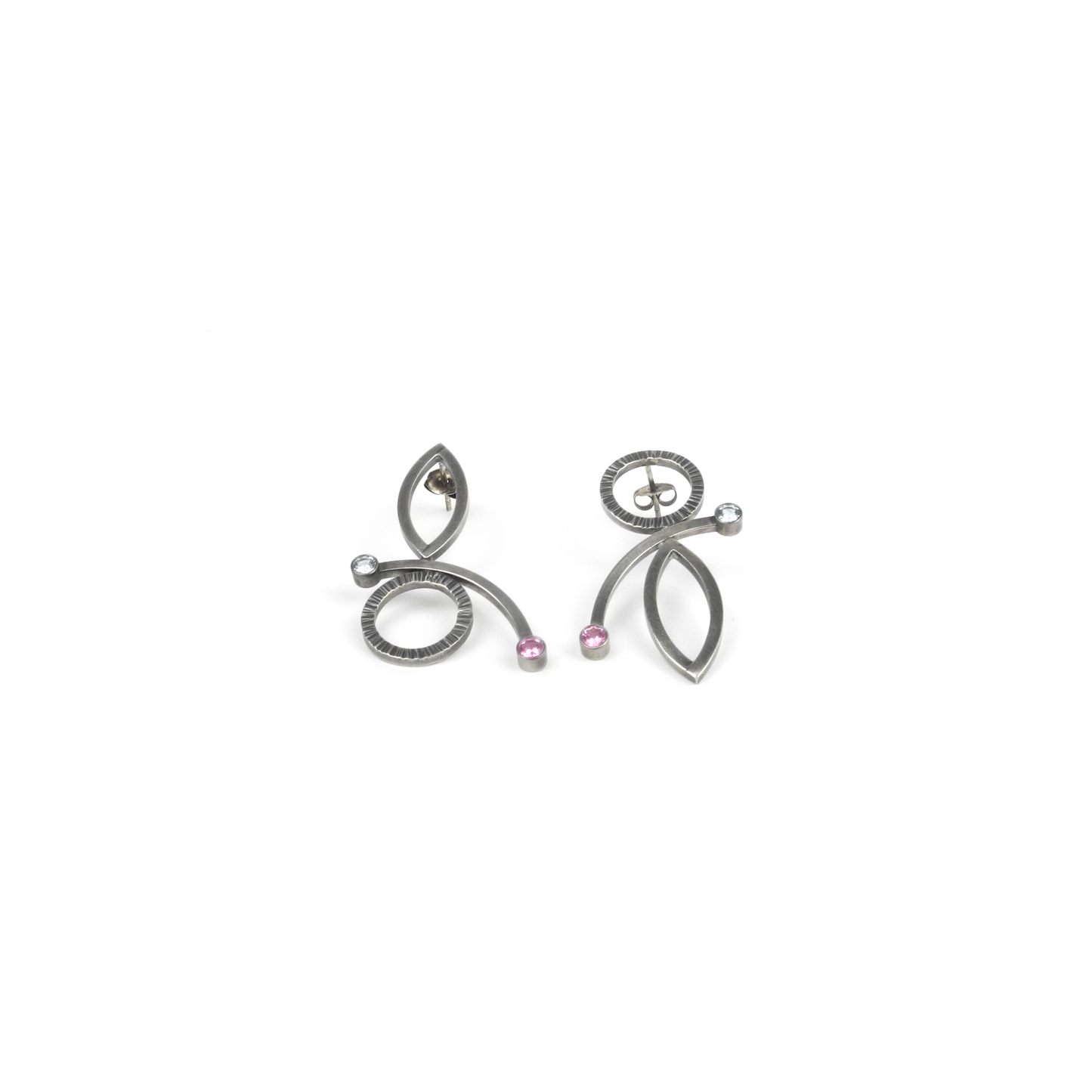 A pair of abstract metallic earrings with circles, ovals, curves, and small pink and clear gemstones.