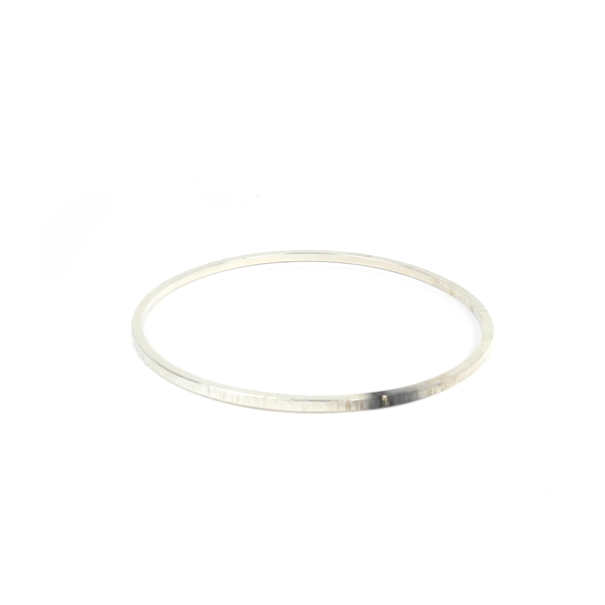 A thin, circular, metallic bangle.