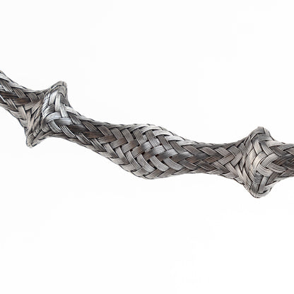 Close-up of a braided stainless steel cuff bracelet section, slightly curved, on a white background.