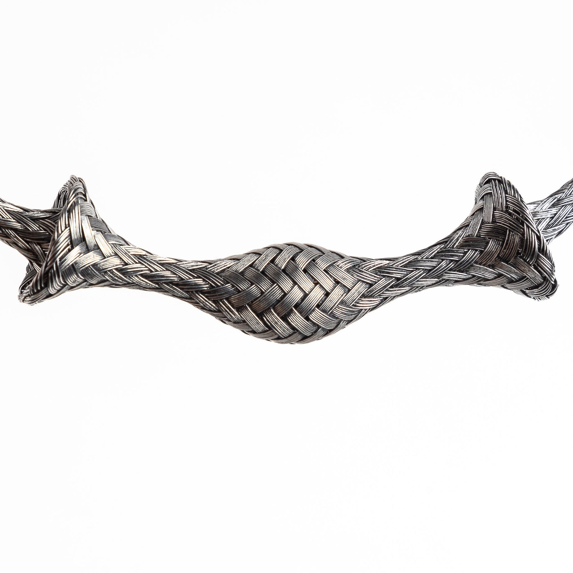 Close-up of a braided stainless steel cuff bracelet section, slightly curved, on a white background.
