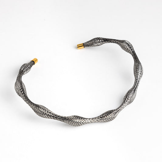 Curved stainless steel braided necklace with gold end caps, angled.