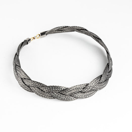 Braided stainless steel necklace with gold clasp, slightly angled, on a white background.