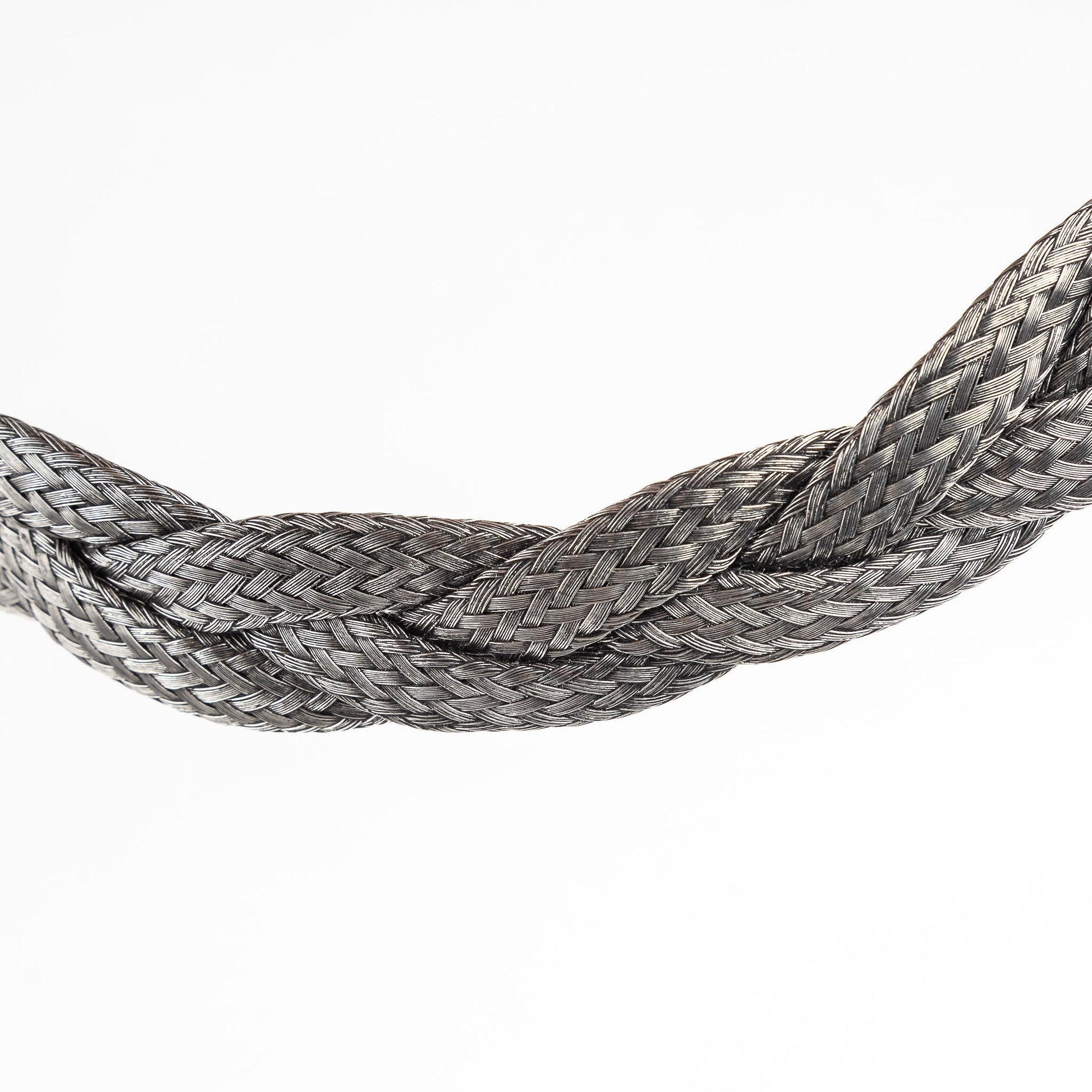Close-up of a braided stainless steel necklace section.