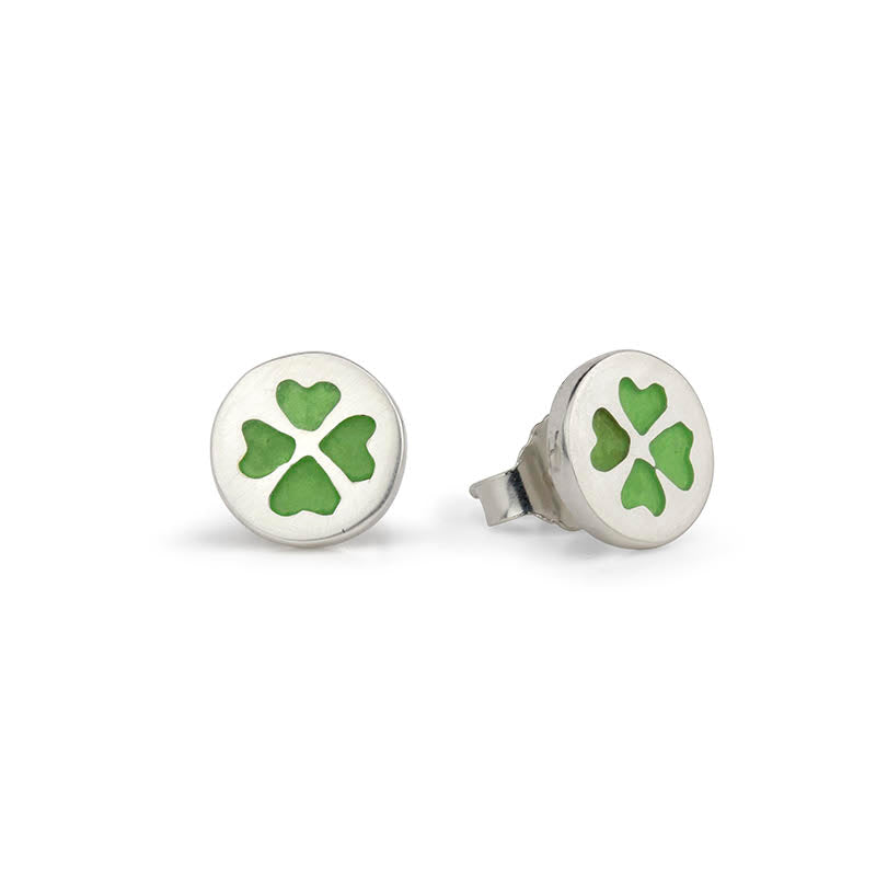 Two silver stud earrings, each with a round setting showing a green four-leaf clover.