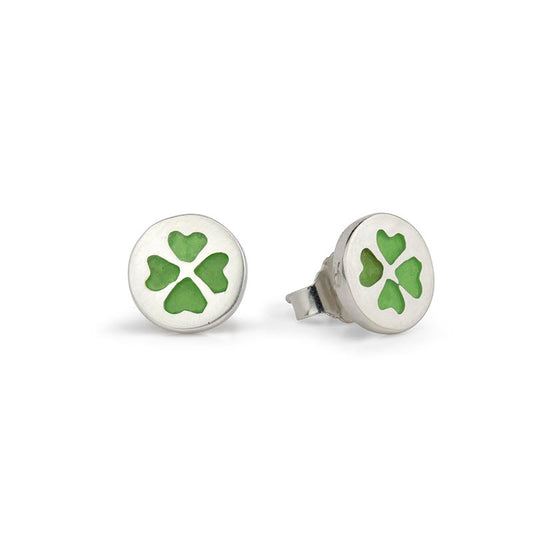 Two silver stud earrings, each with a round setting showing a green four-leaf clover.