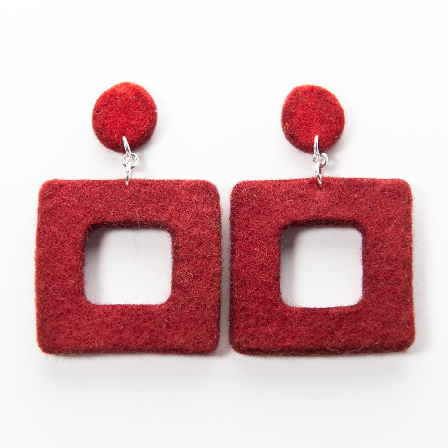 Two red felt square drop earrings with matching red round studs.